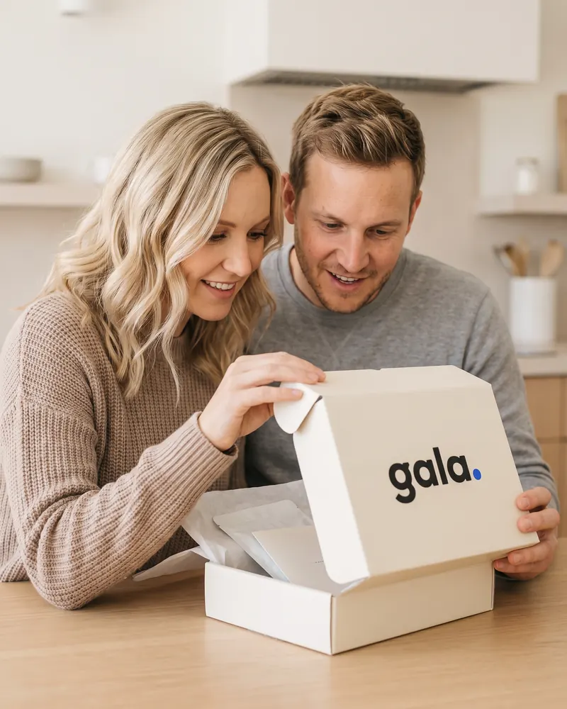 The couple opening their Gala kit at the kitchen table